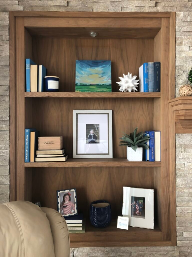 how to style a bookcase, mixing picture frames and books, decorating with books